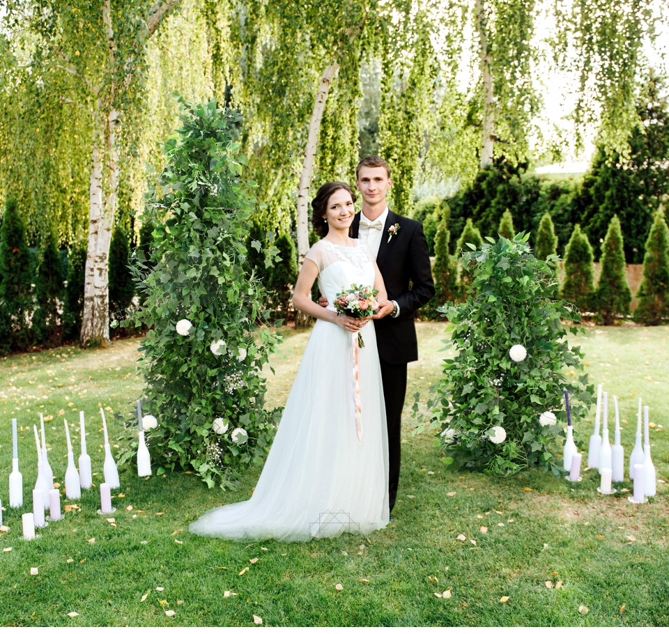 greenery nad flowers laying on sweet heart table